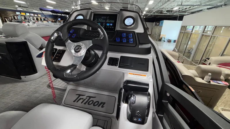 Slide: The Image of Interior view of 2025 JC Neptoon 25TT Sport boat cockpit with steering wheel and controls. - 24