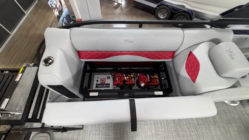 Slide: The Image of 2025 JC Neptoon 25TT Sport boat interior with red and gray seating and battery compartment. - 10
