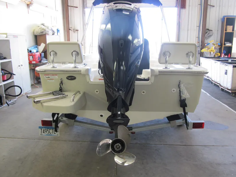 Slide: The Image of 2018 Boston Whaler 170 Montauk boat in garage, rear view with motor and trailer. - 2