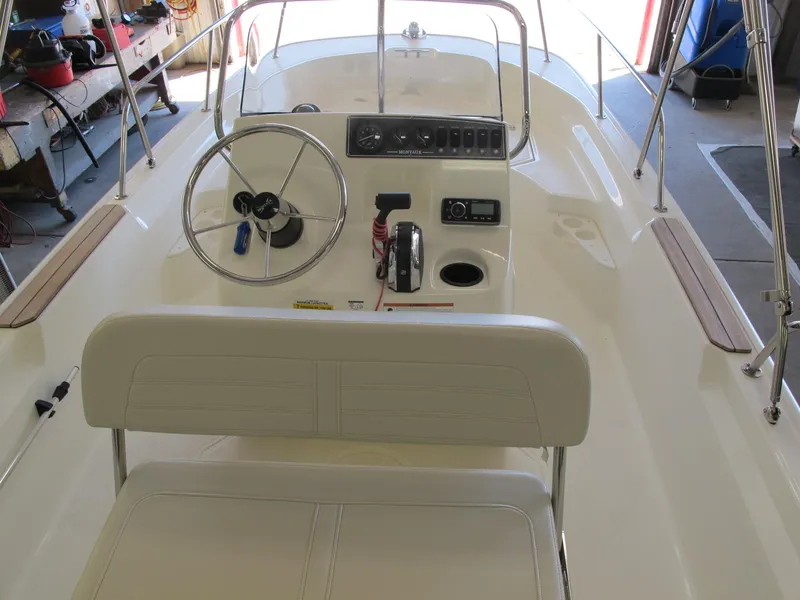 Slide: The Image of 2018 Boston Whaler 170 Montauk boat interior with steering wheel and control panel. - 3
