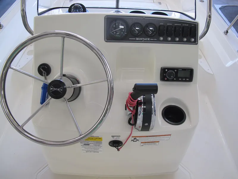 Slide: The Image of 2018 Boston Whaler 170 Montauk boat console with steering wheel and controls. - 5