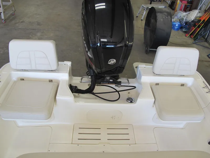 Slide: The Image of 2018 Boston Whaler 170 Montauk boat interior with motor and seating. - 7