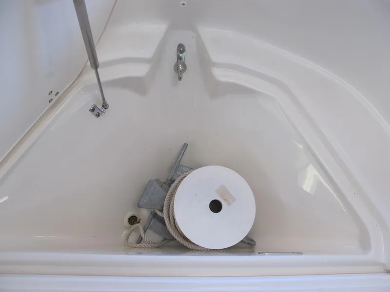 Slide: The Image of 2018 Boston Whaler 170 Montauk anchor storage compartment with rope and anchor. - 9