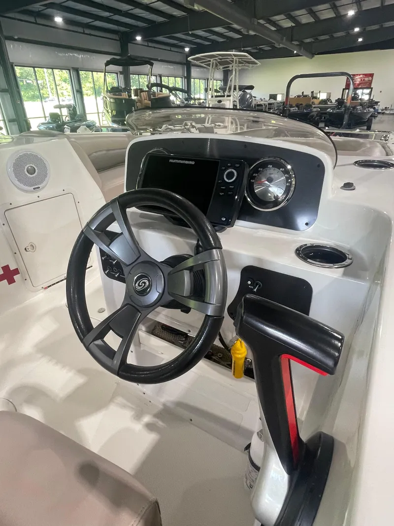 Slide: The Image of 2014 Hurricane SunDeck Sport 188 OB boat dashboard with steering wheel and controls. - 5