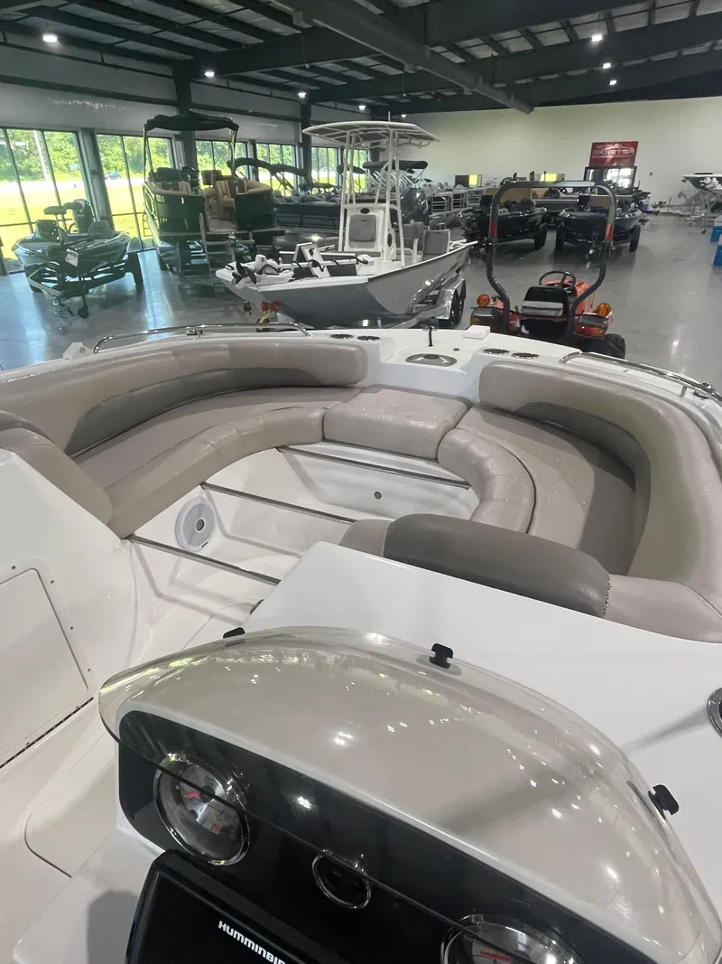 Slide: The Image of 2014 Hurricane SunDeck Sport 188 OB boat interior with seating, displayed in a showroom. - 6