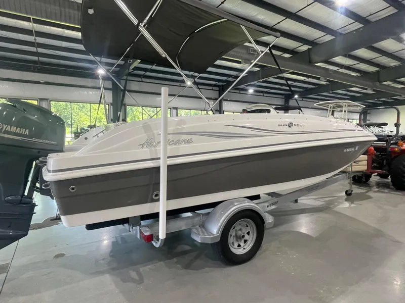 Slide: The Image of 2014 Hurricane SunDeck Sport 188 OB boat on trailer in indoor showroom. - 7