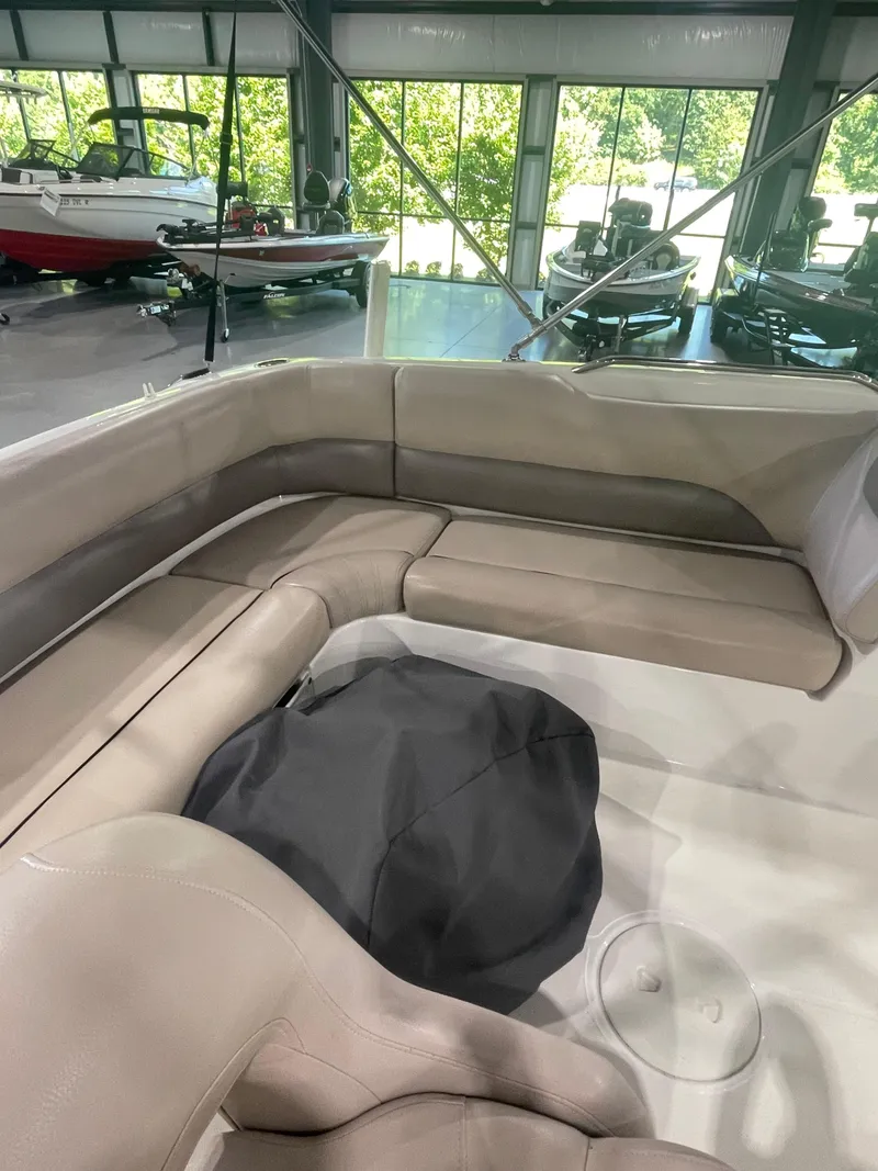 Slide: The Image of 2014 Hurricane SunDeck Sport 188 OB boat interior with beige seating in showroom. - 8