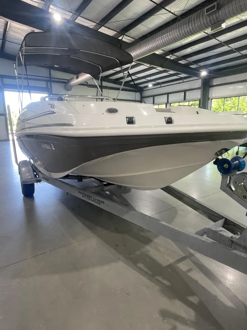 Slide: The Image of 2014 Hurricane SunDeck Sport 188 OB boat on trailer in indoor storage facility. - 9