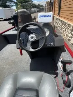 Slide: The Image of 2022 Tracker Bass Tracker Classic XL boat interior with steering wheel and Lowrance equipment. - 4