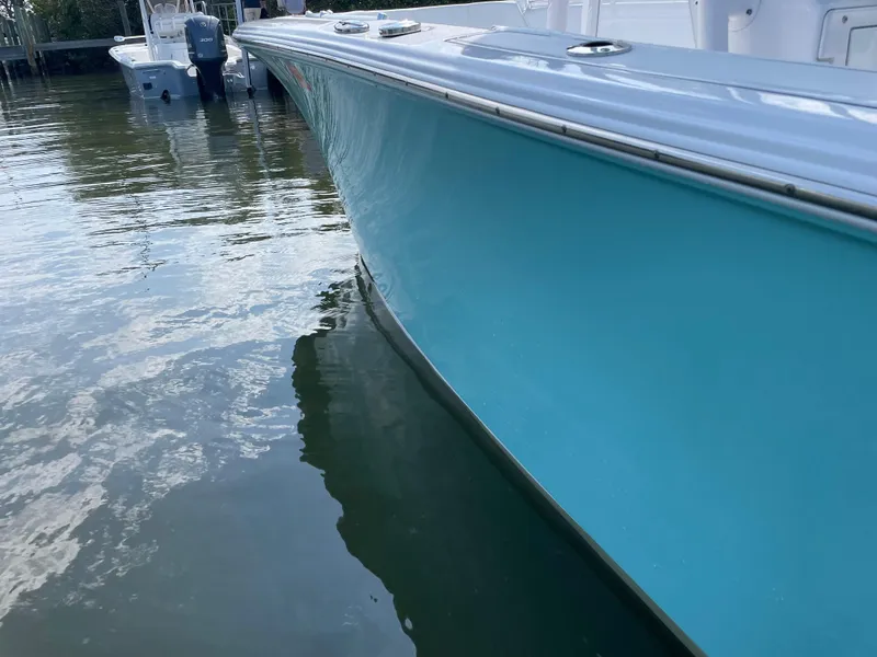 Slide: The Image of 2023 Sportsman Heritage 231 Center Console boat docked in calm water. - 10
