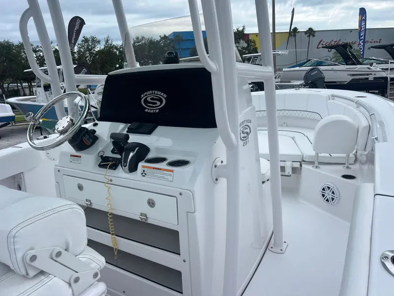 Slide: The Image of 2023 Sportsman Heritage 231 Center Console boat interior with steering wheel and seating. - 13