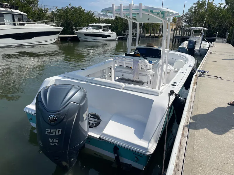 Slide: The Image of 2023 Sportsman Heritage 231 Center Console boat docked with Yamaha 250 V6 engine. - 3