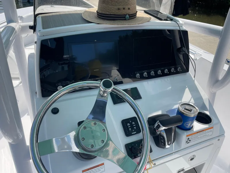 Slide: The Image of 2023 Sportsman Heritage 231 Center Console dashboard with steering wheel and controls. - 4