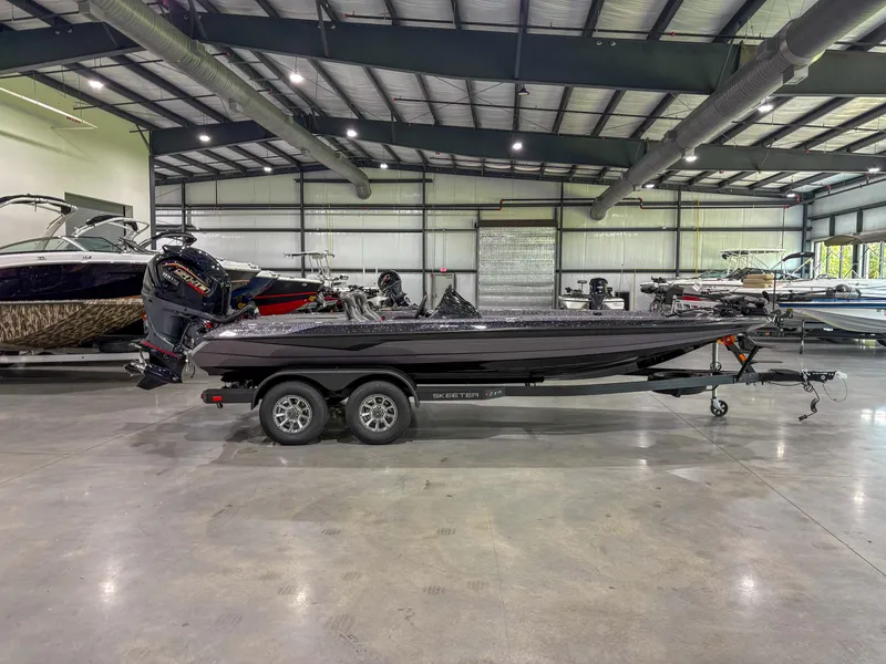 The Image of 2025 Skeeter ZXR 21 SE boat in showroom, side view, on trailer. - 1