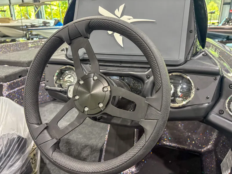 Slide: The Image of Steering wheel of 2025 Skeeter ZXR 21 SE boat, featuring modern dashboard design. - 9