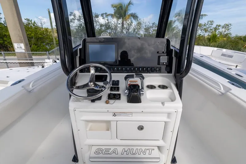 Slide: The Image of 2019 Sea Hunt Ultra 275 SE boat console with steering wheel and controls. - 11
