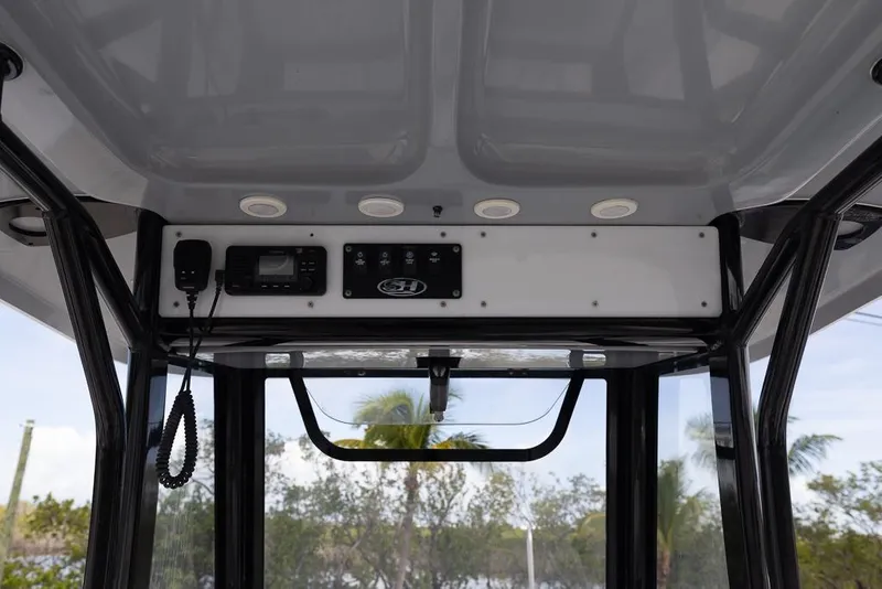 Slide: The Image of 2019 Sea Hunt Ultra 275 SE boat console with electronics and overhead view. - 12