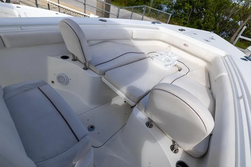 Slide: The Image of 2019 Sea Hunt Ultra 275 SE boat interior with white cushioned seating. - 15