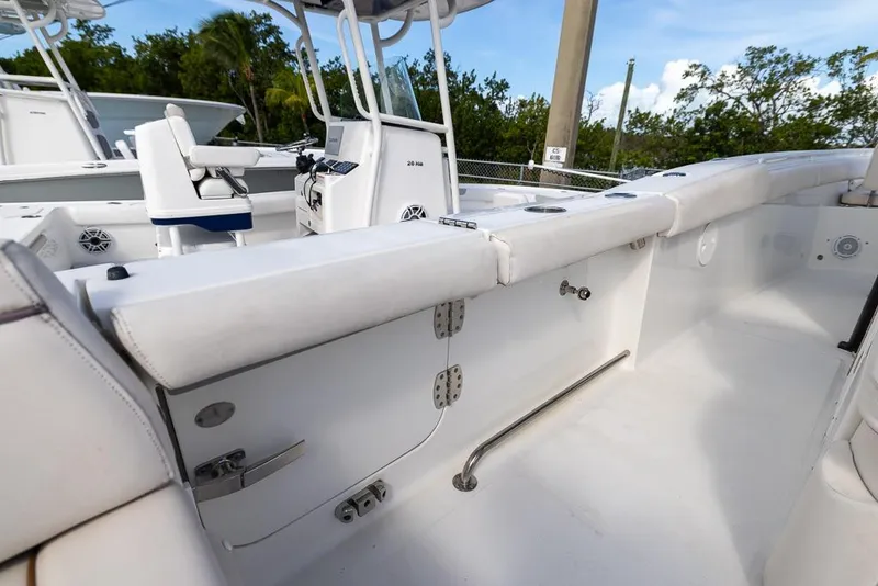 Slide: The Image of 2019 Sea Hunt Ultra 275 SE boat interior with white seating and control console. - 18
