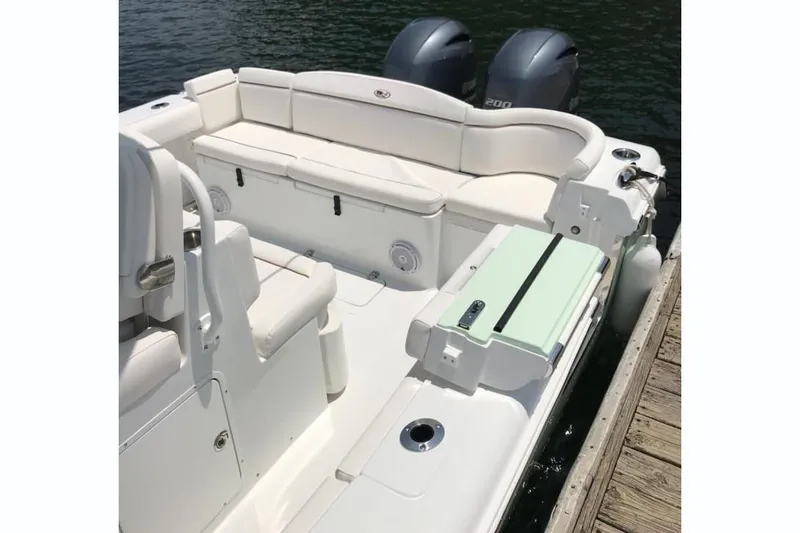 Slide: The Image of 2019 Sea Hunt Ultra 275 SE boat interior with seating and dual engines. - 8