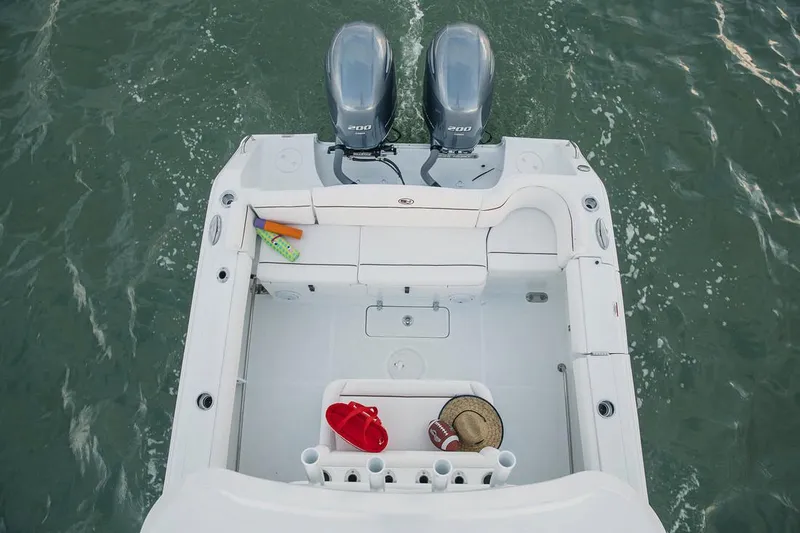 Slide: The Image of 2019 Sea Hunt Ultra 275 SE boat interior with white seating and console. - 9