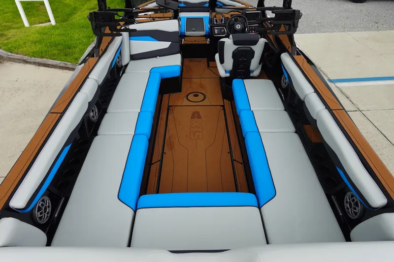 Slide: The Image of 2023 Axis T250 boat interior with blue and gray seating, modern dashboard, and spacious layout. - 10