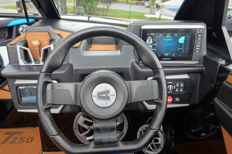 Slide: The Image of 2023 Axis T250 boat dashboard with steering wheel and Garmin display. - 11