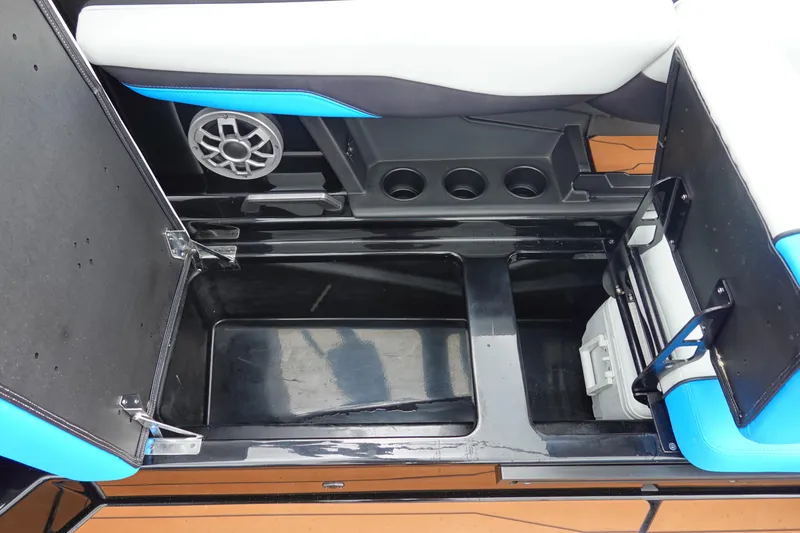 Slide: The Image of 2023 Axis T250 boat storage compartment with cup holders and speaker. - 18