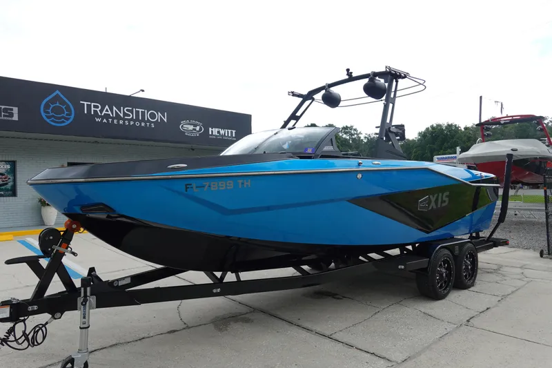 Slide: The Image of 2023 Axis T250 boat in blue on a trailer at Transition Watersports. - 2