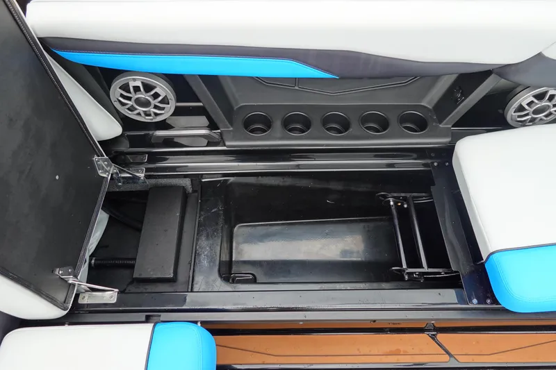 Slide: The Image of 2023 Axis T250 boat interior storage compartment with cup holders and speaker. - 23