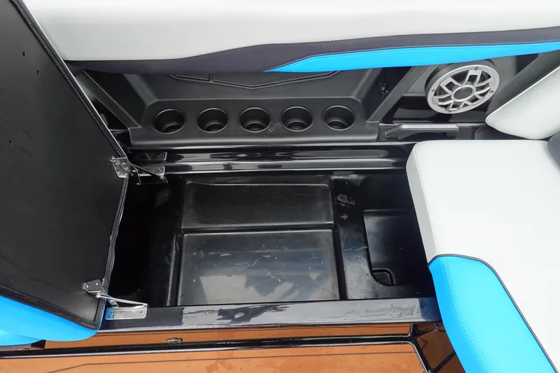 Slide: The Image of 2023 Axis T250 boat storage compartment with cup holders and speaker. - 24