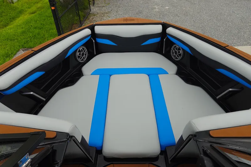 Slide: The Image of 2023 Axis T250 boat interior with gray and blue seating, featuring built-in speakers. - 29