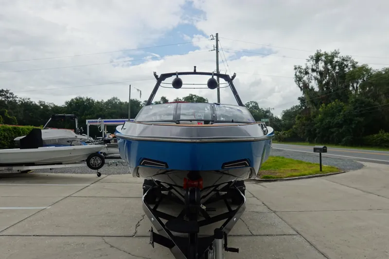 Slide: The Image of 2023 Axis T250 boat on trailer, parked outdoors, front view. - 3