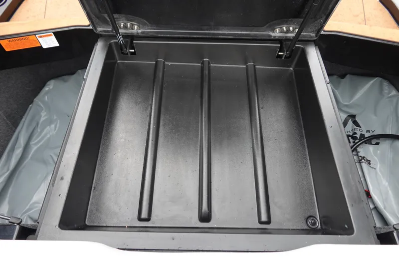 Slide: The Image of 2023 Axis T250 storage compartment, open lid, black interior, spacious design. - 34