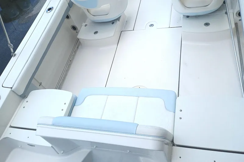 Slide: The Image of 2024 Robalo R207 Dual Console boat interior with white and light blue seating. - 10
