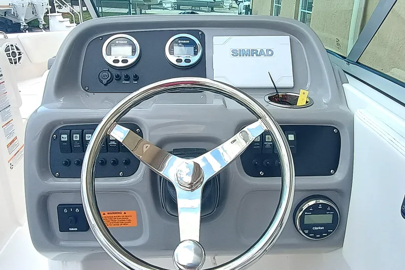 Slide: The Image of 2024 Robalo R207 Dual Console dashboard with steering wheel and control panel. - 12