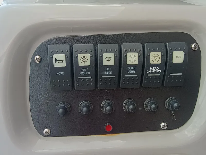 Slide: The Image of Control panel of 2024 Robalo R207 Dual Console boat with labeled switches. - 15