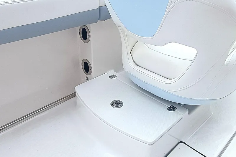 Slide: The Image of 2024 Robalo R207 Dual Console interior seating and storage compartment detail. - 17