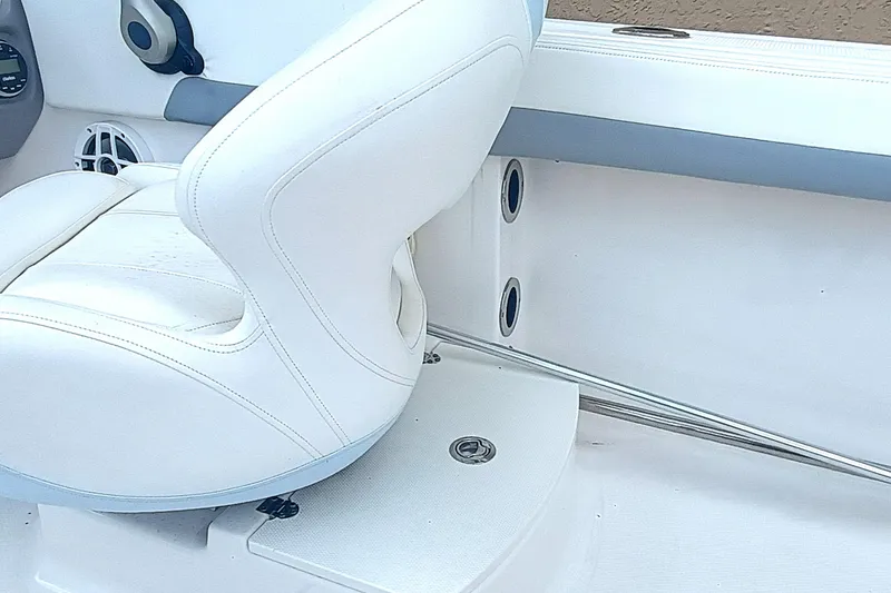 Slide: The Image of 2024 Robalo R207 Dual Console interior with white seating and sleek design. - 18