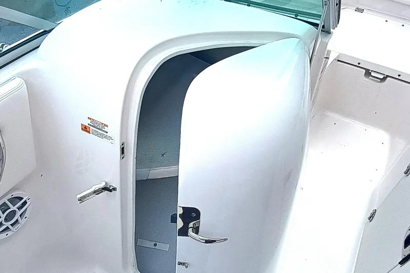 Slide: The Image of 2024 Robalo R207 Dual Console boat interior with open storage compartment. - 19