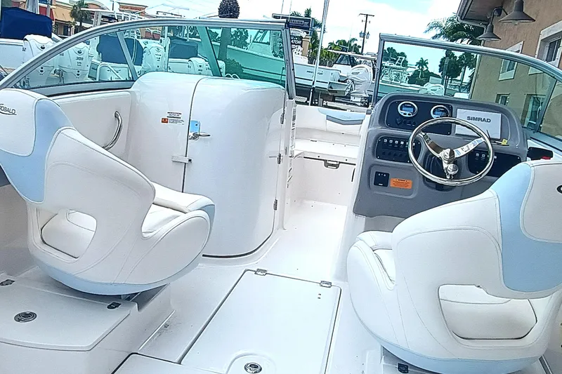 Slide: The Image of 2024 Robalo R207 Dual Console boat interior with white seating and modern dashboard. - 20