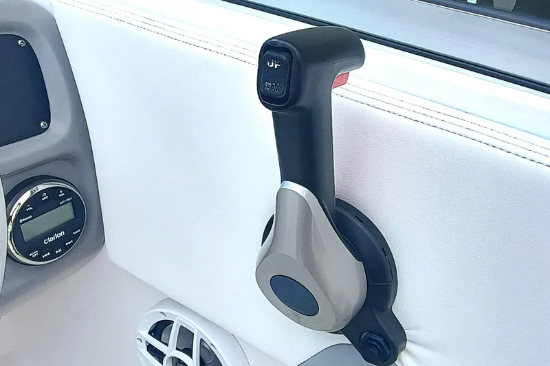 Slide: The Image of Throttle control and audio system on 2024 Robalo R207 Dual Console boat. - 21