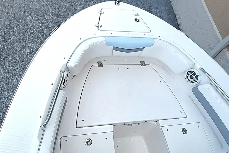 Slide: The Image of 2024 Robalo R207 Dual Console boat interior with seating and storage compartments. - 24