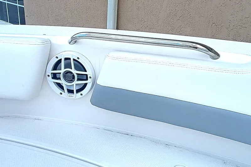 Slide: The Image of 2024 Robalo R207 Dual Console interior with speaker and stainless steel handrail. - 27
