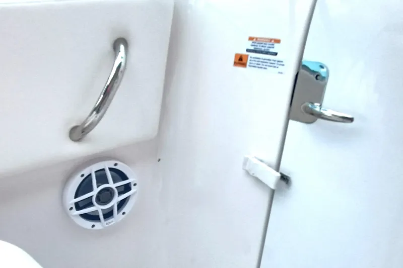 Slide: The Image of 2024 Robalo R207 Dual Console interior with speaker and handle details. - 29