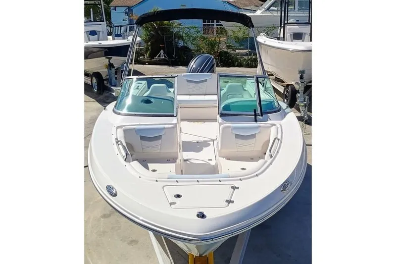 Slide: The Image of 2024 Robalo R207 Dual Console boat with open bow seating and sleek design. - 7