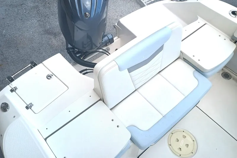 Slide: The Image of 2024 Robalo R207 Dual Console boat interior with seating and engine view. - 8