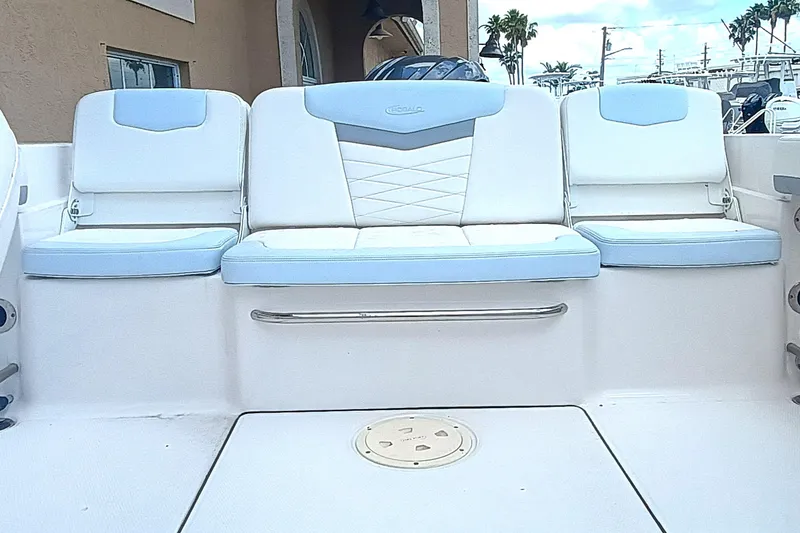 Slide: The Image of 2024 Robalo R207 Dual Console boat seating, featuring white and light blue cushioned seats. - 9
