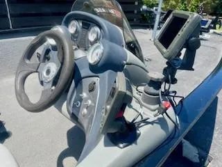 Slide: The Image of 2017 Tracker Pro Team 195 TXW boat dashboard with steering wheel and gauges. - 5