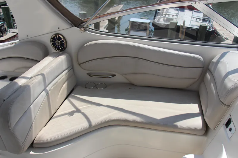 Slide: The Image of 2008 Larson Cabrio 260 boat interior with beige seating and cup holders. - 10